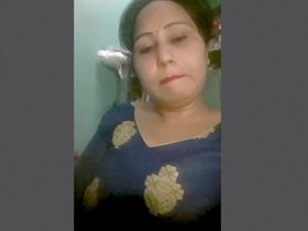 Enticing aunt displays her allure in the kitchen