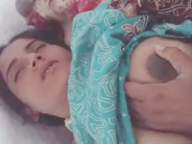 A Pakistani wife moans with pleasure as she masturbates with a large penis