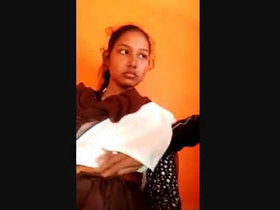Indian babe's large breasts are held down in steamy video