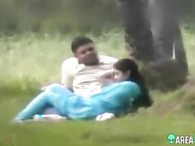 Beautiful wife in a blue sari with her lover in a public park