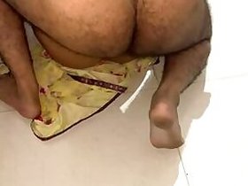 Skinny wife Desi in a yellow sari has missionary XXX sex in the bathroom